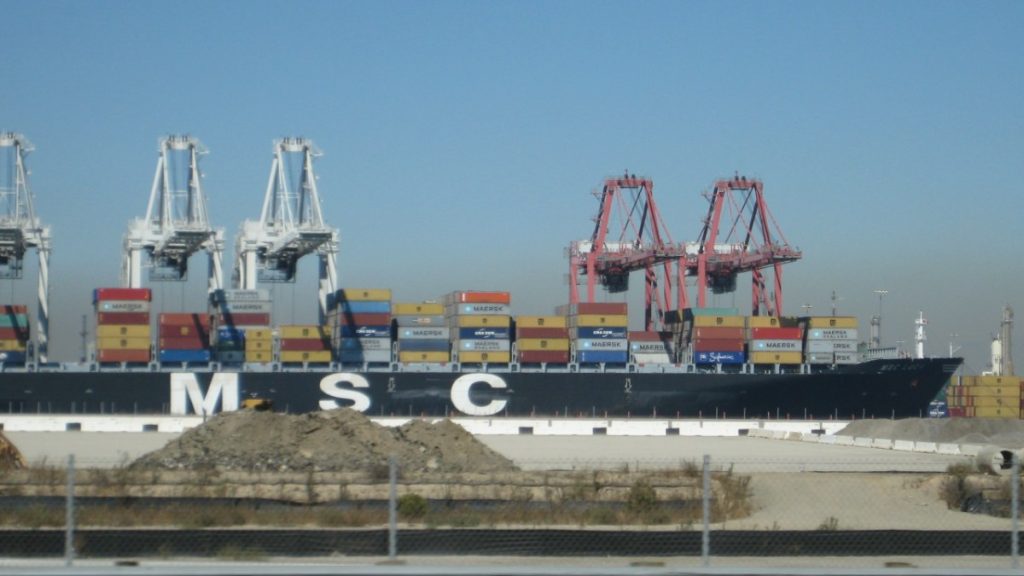 Container ship loaded with containers beside cranes at the Port of Long Beach, California
